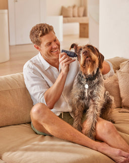 Dr Chris Brown applying ear cleaner to a dog's ear
