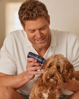 Dr Chris Brown applying the highly rated Ear De-Gunker ear cleaner to a dog's ear